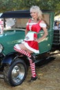 Christmas dirndl pinup woman and classic Model T Royalty Free Stock Photo