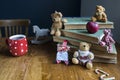 A Christmas doll and bears sit on a stack of old books Royalty Free Stock Photo