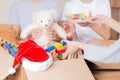 Christmas donation. Volunteers collect donations for charity indoors. Cardboard boxes with kid toys, school supplies Royalty Free Stock Photo