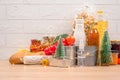 Christmas donations - food donations on light background with copyspace - pasta, fresh vegatables, canned food, baguette, cooking