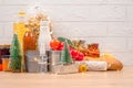 Christmas donations - food donations on light background with copyspace - pasta, fresh vegatables, canned food, baguette, cooking