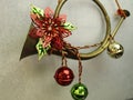 Christmas door decoration.. horn with festive bells and poinsetta wire with green leaes Royalty Free Stock Photo