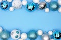 Christmas double border of blue, white and silver ornaments over blue Royalty Free Stock Photo