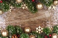 Christmas double border with gold ornaments, branches on rustic wood Royalty Free Stock Photo