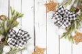 Christmas double corner border with branches, ornaments and black and white checked buffalo plaid gifts, above view on a white woo Royalty Free Stock Photo