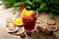 Christmas drink. Glass of hot mulled wine with oranges, anise and cinnamon Royalty Free Stock Photo