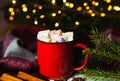 Christmas drink hot chocolate or cocoa with marshmallows in a red cup on the table. Festive homemade dessert in a cup. Close-up Royalty Free Stock Photo