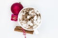 Christmas drink: hot chocolate with marshmallows in a cup among red decorations on a white background. Christmas, winter holidays Royalty Free Stock Photo