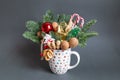 Christmas edible bouquet with nuts, sweets, nobilis and christmas decor in a cup