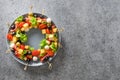 Christmas edible wreath of holiday snacks, canapes, tomatoes, olive, vegetables, cheese