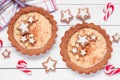 Christmas eggnog and gingerbread tart table scene against white wood Royalty Free Stock Photo