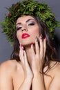 Christmas elegant fashion woman. Xmas New Year hairstyle and makeup. Gorgeous Vogue style Lady with Christmas decorations on her Royalty Free Stock Photo