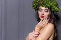 Christmas elegant fashion woman. Xmas New Year hairstyle and makeup. Gorgeous Vogue style Lady with Christmas decorations on her Royalty Free Stock Photo