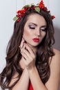 Christmas elegant fashion woman. Xmas New Year hairstyle and makeup. Gorgeous Vogue style Lady with Christmas decorations on her Royalty Free Stock Photo