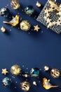 Christmas elegant vertical holiday card featuring chic navy and gold tones. The festive design showcases a sparkling baubles, gift