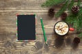 Christmas empty black blank for letter to Santa and christmas tree branches on the wooden board. Top view, copy space. Royalty Free Stock Photo