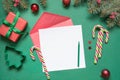 Christmas empty blank letter to Santa or invitation on green. Top view. Royalty Free Stock Photo