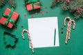 Christmas empty blank letter to Santa or invitation on green. Top view Royalty Free Stock Photo