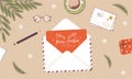 Christmas envelope on desk. Handmade greeting card. Sending or receiving New Year postcard or invitation. Top view