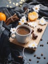 Christmas espresso coffee on the table with a garland in the shape of a Christmas tree, tangerines, cinnamon, anise . Home morning