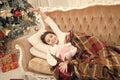 Christmas eve. Dreaming about christmas miracle. Small cute girl dreaming about christmas gift. Happy childhood. Small