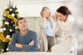 Elderly mother and woman during family quarrel accuse adult man on Christmas Eve Royalty Free Stock Photo