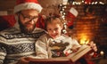Christmas Eve. family father and child reading magic book at home Royalty Free Stock Photo