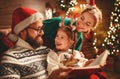 Christmas Eve. family father, mother and child reading magic book at home Royalty Free Stock Photo