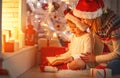 Christmas Eve. family mother and child daughter reading magic bo Royalty Free Stock Photo