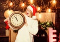 Christmas Eve. girl in red santa claus hat. Midnight. winter holidays. Its time for christmas. Cheerful woman.. Time to Royalty Free Stock Photo