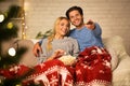 Christmas eve. Loving couple watching tv at home Royalty Free Stock Photo