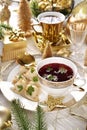 Christmas Eve red borscht with dumplings on festive table in white and gold colors Royalty Free Stock Photo