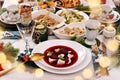 Christmas Eve red borscht with ravioli and beet chips and other dishes Royalty Free Stock Photo