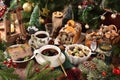 Christmas Eve supper with traditional Polish dishes and pastries on rustic style table Royalty Free Stock Photo