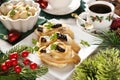 Christmas Eve table with mini canapes with herring fillets with prune