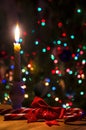 Christmas evening, a burning candle on the background of a Christmas tree Royalty Free Stock Photo