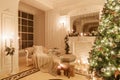 Classical interior of a white room. Christmas evening by candlelight. classic apartments with a white fireplace Royalty Free Stock Photo