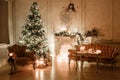 Christmas tree, garlands, candles,lanterns, gifts in the evening. classical interior of a white room with a decorated Royalty Free Stock Photo