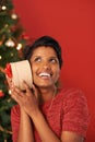 Christmas, excited and woman guess gift in box at home for holiday celebration on mockup space in India. Happy person Royalty Free Stock Photo