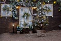 Christmas facade of a wooden house with Christmas trees, wreath, garlands