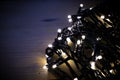 Christmas fairy lights wrapped around card at night Royalty Free Stock Photo