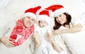 Christmas family with baby in red hats. Royalty Free Stock Photo