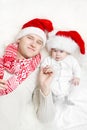 Christmas family:father and baby in red hats.