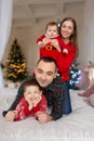 Christmas family Happy mom,dad and little daughter and son, lying down. Enjoyng love hugs, holidays people. Togetherness concept Royalty Free Stock Photo