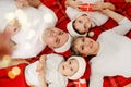 Christmas family at home. Happy mom,dad and sons on Santa Claus hats Royalty Free Stock Photo