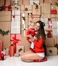 Christmas Family mother and baby toddler Kid on rustic craft presents gift wall Royalty Free Stock Photo