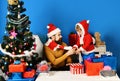 Christmas family opens presents on blue background. Royalty Free Stock Photo