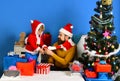 Christmas family opens presents on blue background. Royalty Free Stock Photo