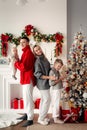 Christmas family portrait: happy parents, kids at Xmas tree and new year gifts together celebrating Royalty Free Stock Photo