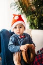 Christmas family portrait of happy smiling little boy in red santa hat in mother`s hands. Winter holiday Xmas and New Year concept Royalty Free Stock Photo